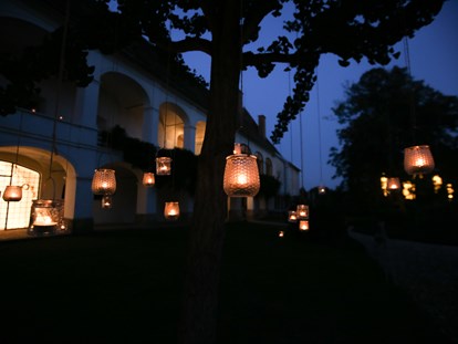 Hochzeit - Sommerhochzeit - Steiermark - Am Abend wird der Schlosspark in warmes Kerzenlicht getaucht und die Bäume erstrahlen im weitläufigen Park - Schloss Welsdorf