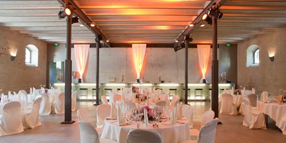 Hochzeit - Berg (Starnberg) - Schlicht und elegant ist der ebenerdige Säulensaal mit seinen gusseisernen Stützsäulen, den geschlämmten Ziegelwänden und der dezent beleuchteten Glastheke an der hinteren Wand.  - Fürstenfelder Gastronomie & Hotel GmbH