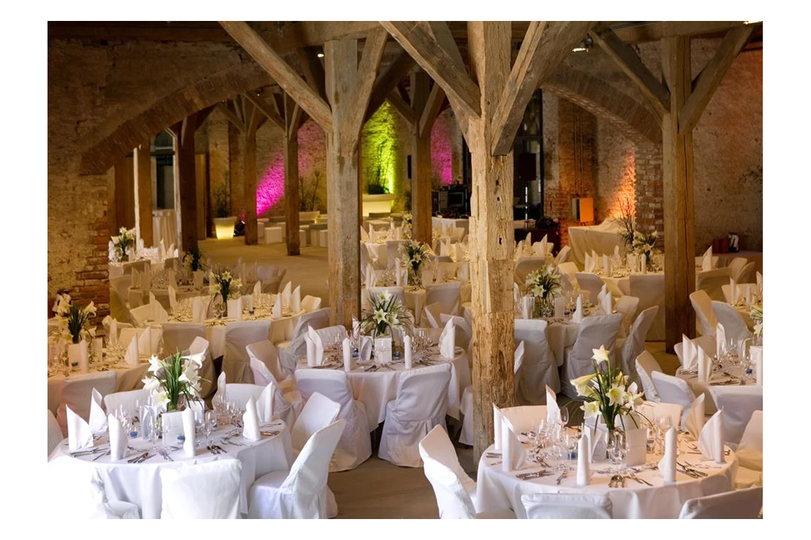 Hochzeit: Die Tenne diente dem Kloster einst als Heustadel. Daran erinnern noch die beiden Auffahrten für die Pferdefuhrwerke. Mit ihrem imposanten Gebälk, dem Dielenboden und den weiten offengelassenen Rundbögen ist sie ein unvergleichlicher Ort. - Fürstenfelder Gastronomie & Hotel GmbH